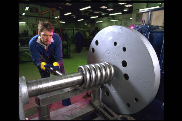 Railway spring being hand coiled 